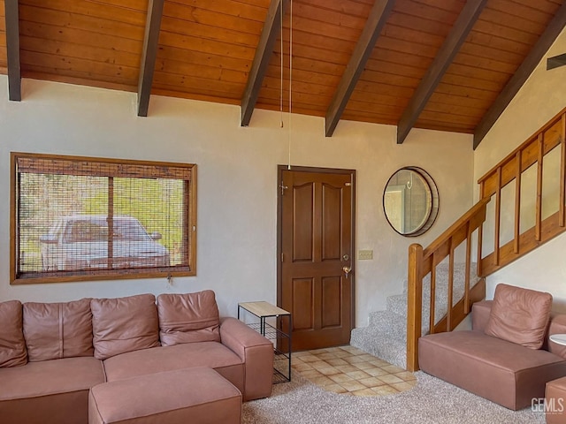 carpeted living area featuring stairway, lofted ceiling with beams, and wood ceiling