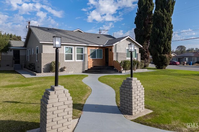 ranch-style home with a front lawn