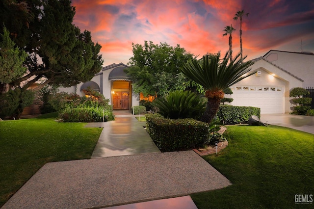 7305 Wilford Ct, Bakersfield, CA 93309 - view of property hidden behind natural elements featuring a lawn, concrete driveway, stucco siding, and an attached garage