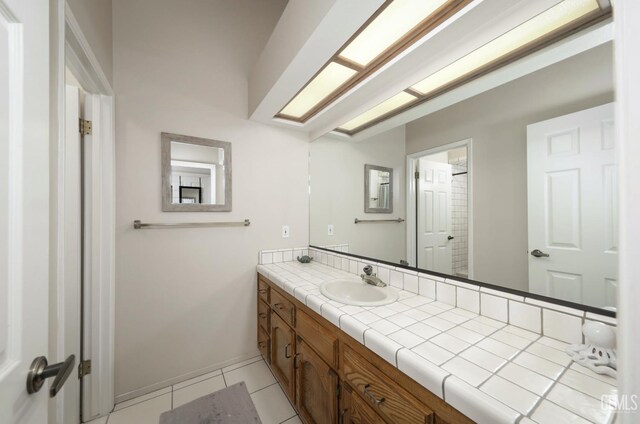 7305 Wilford Ct, Bakersfield, CA 93309 - bathroom with vanity, tile patterned flooring, and baseboards