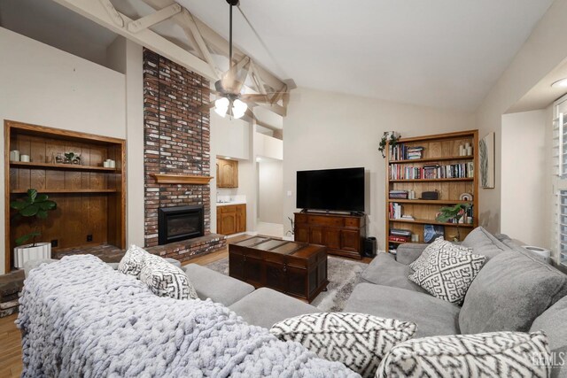 7305 Wilford Ct, Bakersfield, CA 93309 - living room featuring ceiling fan, light wood-type flooring, a brick fireplace, and high vaulted ceiling