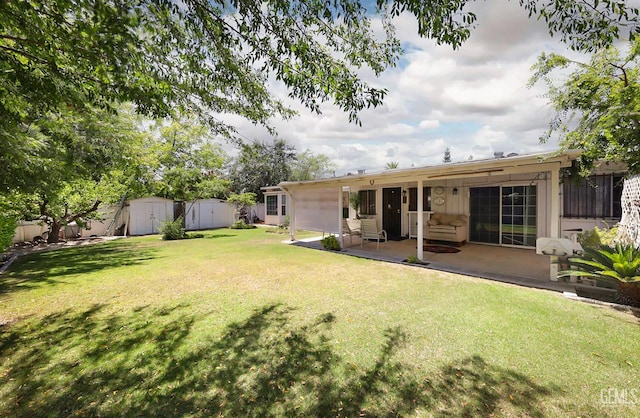 712 River Oaks Dr, Bakersfield, CA 93309 - view of green lawn with a shed and a patio area