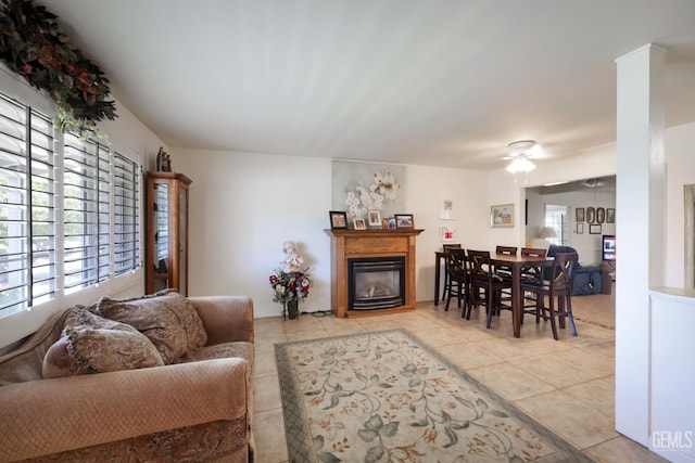 712 River Oaks Dr, Bakersfield, CA 93309 - living area featuring light tile patterned floors, a glass covered fireplace, and ceiling fan