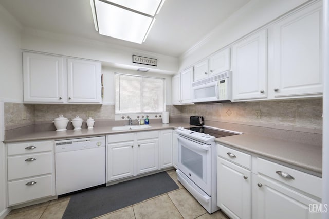 712 River Oaks Dr, Bakersfield, CA 93309 - kitchen with white appliances, white cabinetry, backsplash, light tile patterned floors, and crown molding