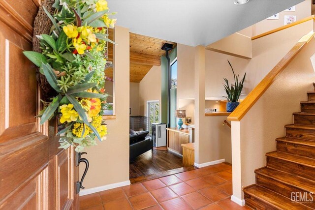 interior details featuring a textured wall and a wood stove