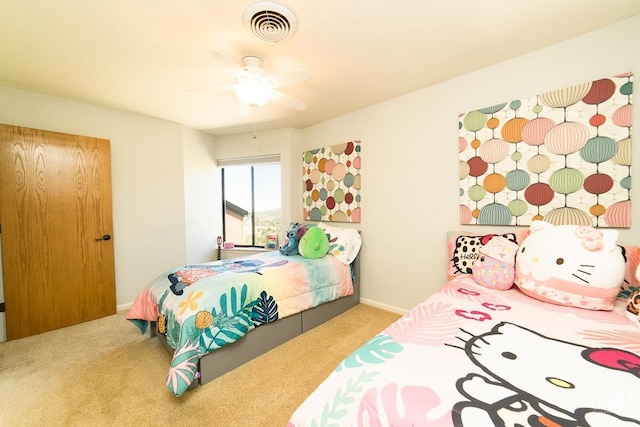 bedroom featuring baseboards, ceiling fan, visible vents, and carpet flooring