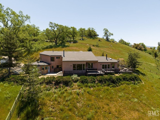 back of house with a wooden deck