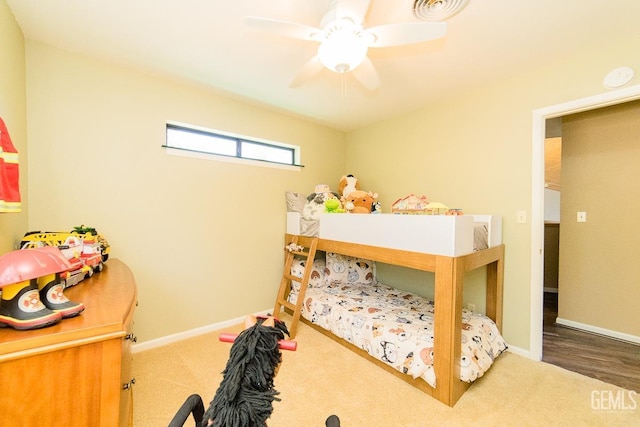 carpeted bedroom featuring visible vents, baseboards, and a ceiling fan