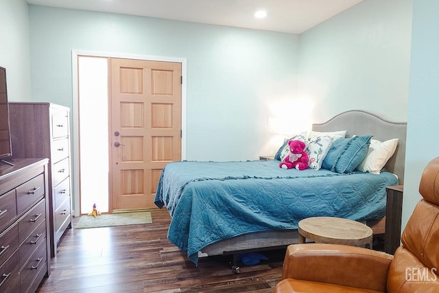 bedroom featuring dark wood-type flooring and recessed lighting