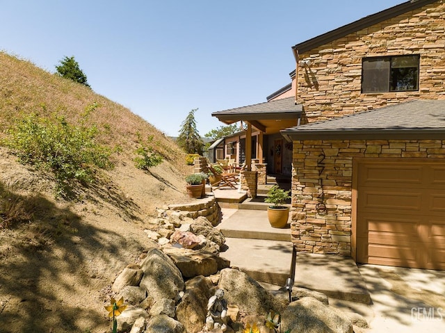 view of yard with a garage and a patio area