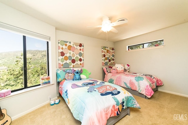 bedroom featuring carpet floors, baseboards, and a ceiling fan