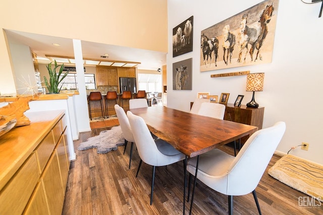 dining space with dark wood-type flooring