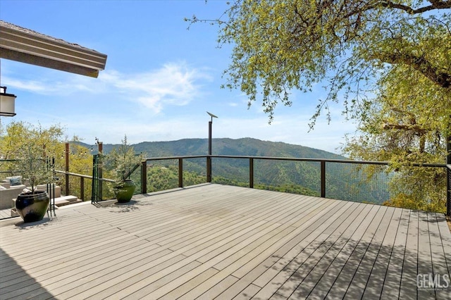 wooden terrace featuring a mountain view