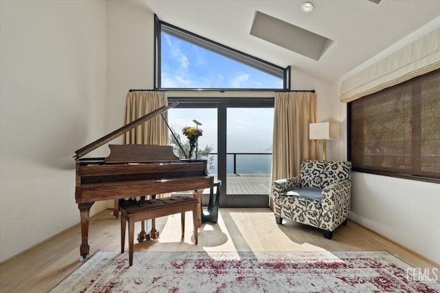 sitting room featuring vaulted ceiling and wood finished floors