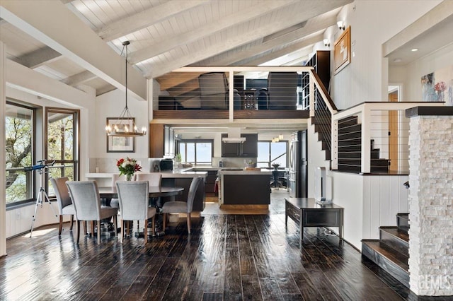 dining space with high vaulted ceiling, a chandelier, beamed ceiling, dark wood-style floors, and stairway