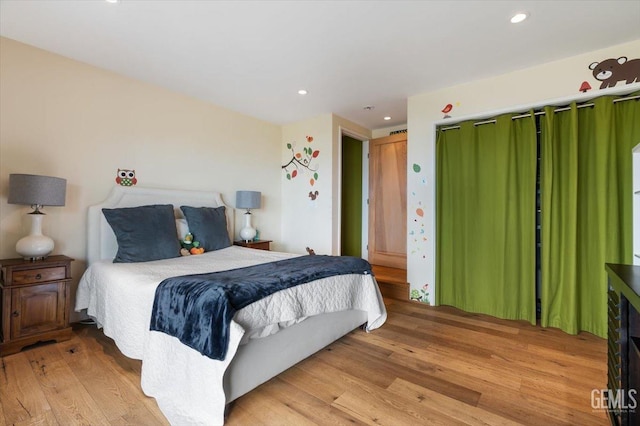 bedroom with recessed lighting and light wood-style floors
