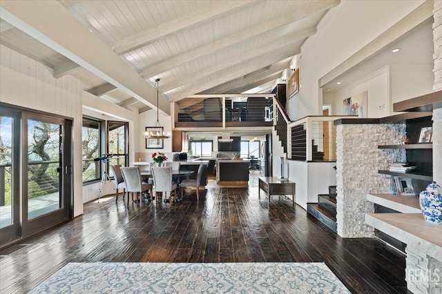 dining space featuring stairway, plenty of natural light, hardwood / wood-style flooring, and beam ceiling