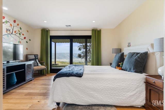 bedroom with recessed lighting, visible vents, access to exterior, and light wood finished floors