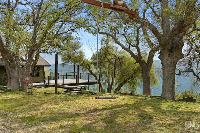 surrounding community with a lawn and a wooden deck