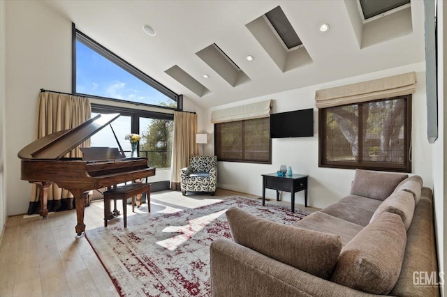 living room featuring recessed lighting, high vaulted ceiling, and light wood-type flooring
