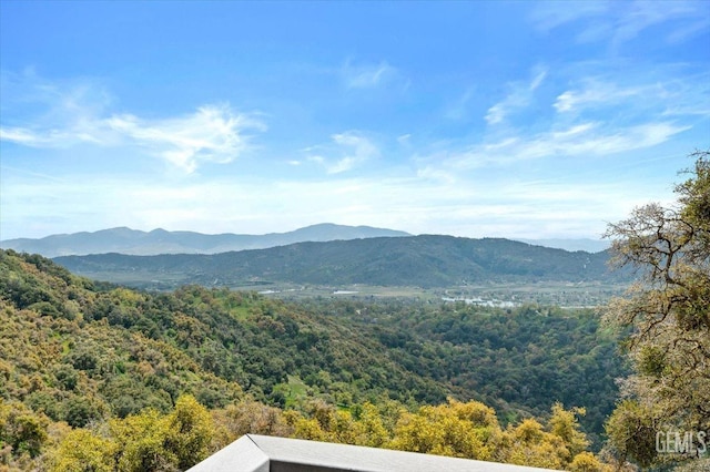 mountain view with a wooded view