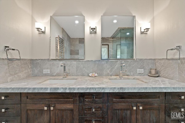 full bath with double vanity, a sink, and tasteful backsplash