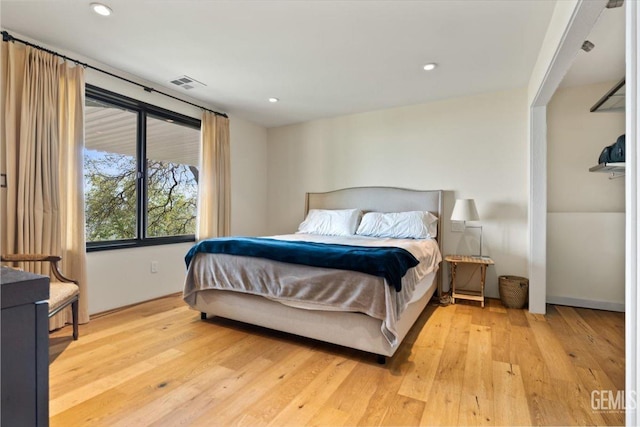 bedroom featuring visible vents, recessed lighting, and hardwood / wood-style flooring
