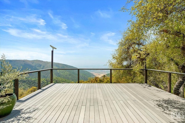 wooden deck with a mountain view