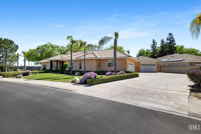 4906 Palisades Cir, Bakersfield, CA 93308 - view of front of home with an attached garage, concrete driveway, a tile roof, stucco siding, and a front lawn