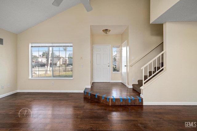 foyer with ceiling fan, dark hardwood / wood-style flooring, and high vaulted ceiling