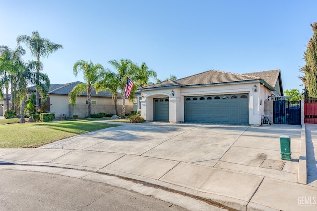 ranch-style house featuring a front yard and a garage