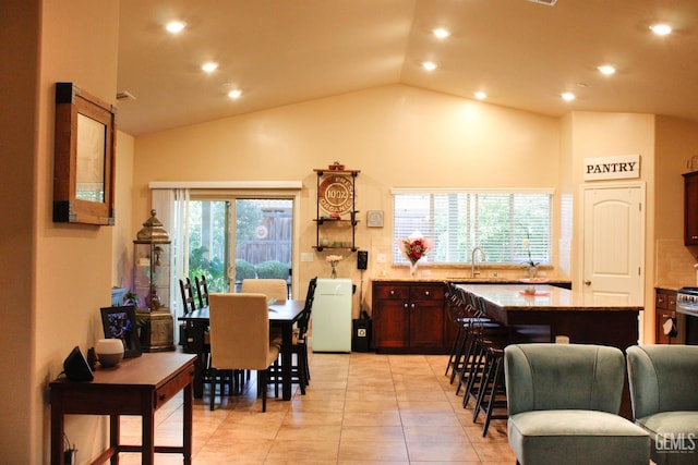 9512 Four Pines Dr, Shafter, CA 93263 - dining area featuring vaulted ceiling, recessed lighting, and light tile patterned floors