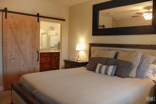 9512 Four Pines Dr, Shafter, CA 93263 - bedroom with a barn door, ensuite bathroom, and ceiling fan