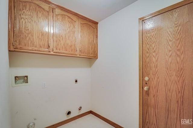 clothes washing area with cabinets, electric dryer hookup, gas dryer hookup, and hookup for a washing machine