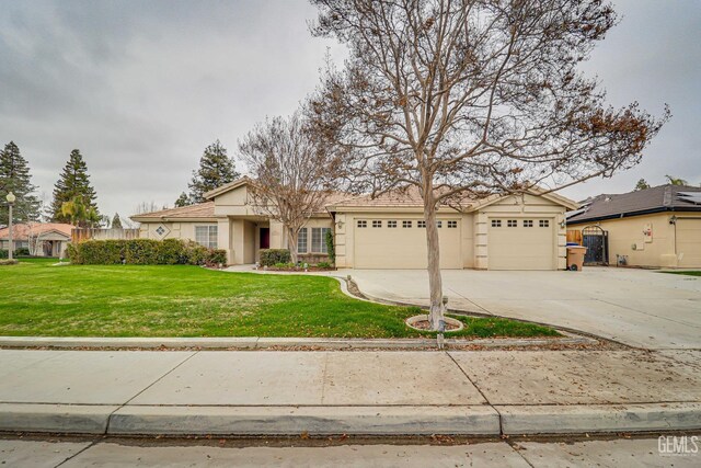 single story home featuring a garage and a front lawn