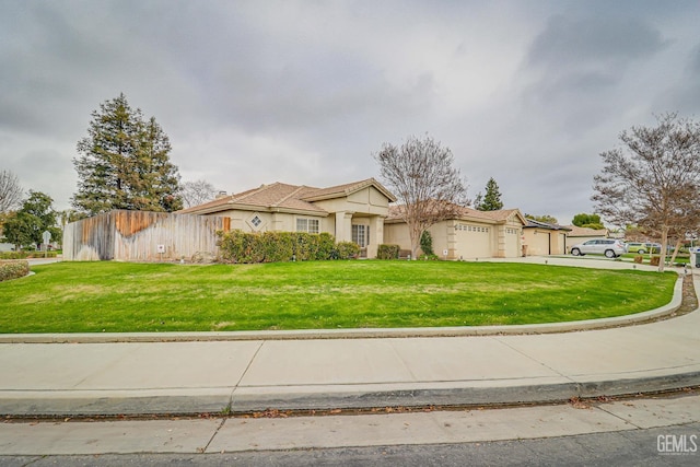 view of front of house with a front yard and a garage