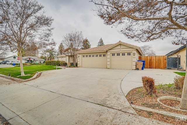 view of front of home featuring a garage and a front lawn