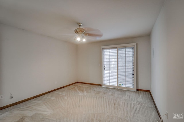 spare room featuring light carpet and ceiling fan