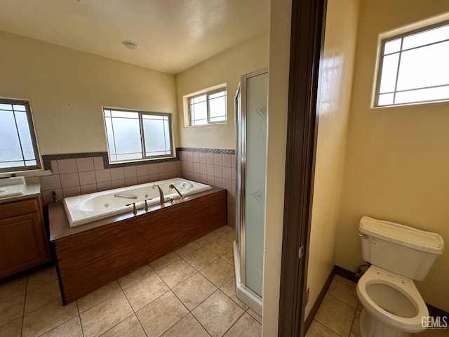 full bath with a tub with jets, toilet, a shower stall, and tile patterned flooring