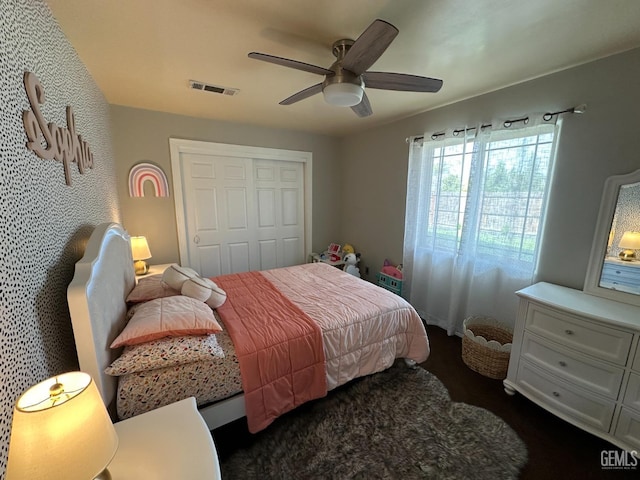 bedroom with a closet, visible vents, and ceiling fan