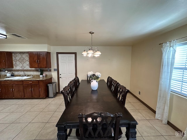 dining area with an inviting chandelier, light tile patterned floors, visible vents, and a wealth of natural light