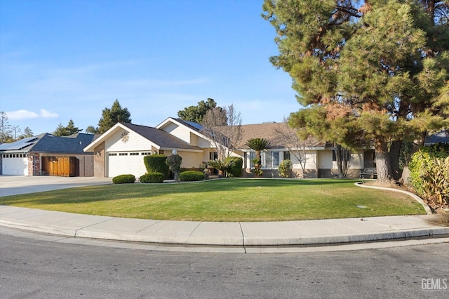 ranch-style home with a garage and a front lawn