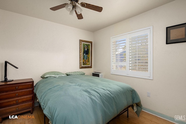 bedroom with ceiling fan and wood-type flooring