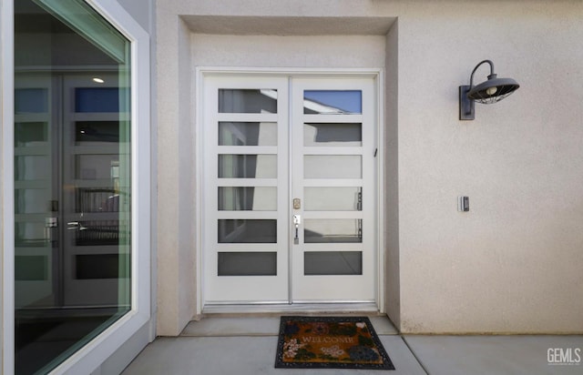 9108 Manor Forest Ln, Shafter, CA 93263 - view of exterior entry featuring french doors and stucco siding