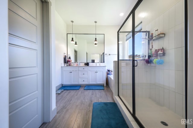 9108 Manor Forest Ln, Shafter, CA 93263 - full bath featuring double vanity, a stall shower, wood finished floors, and a bath