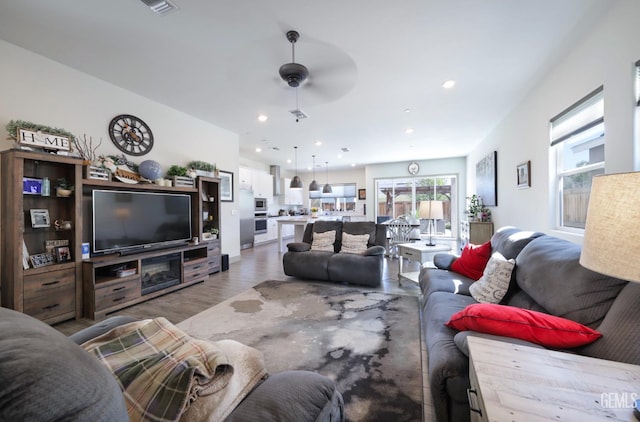 9108 Manor Forest Ln, Shafter, CA 93263 - living room with wood finished floors, a ceiling fan, and recessed lighting