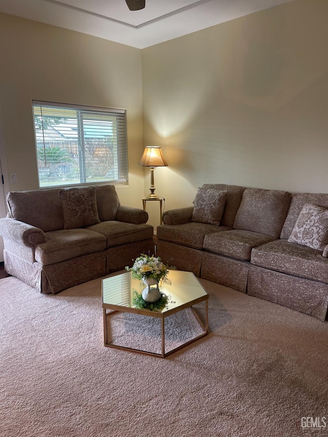 carpeted living room with ceiling fan