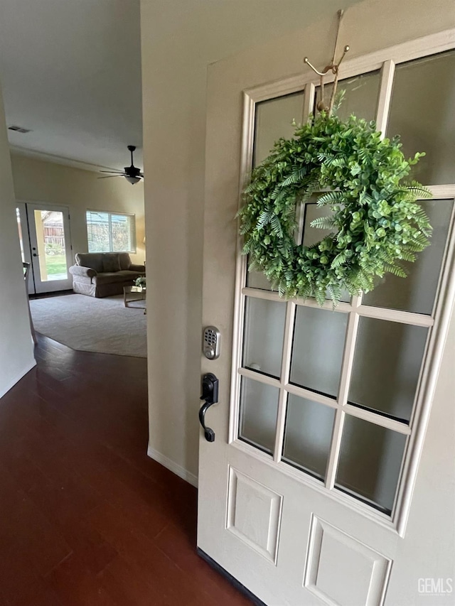 interior space with ceiling fan