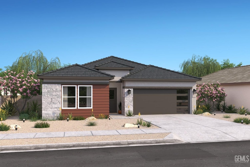 6312 Marconi Ave, Bakersfield, CA 93313 - view of front facade with an attached garage, concrete driveway, stone siding, and stucco siding