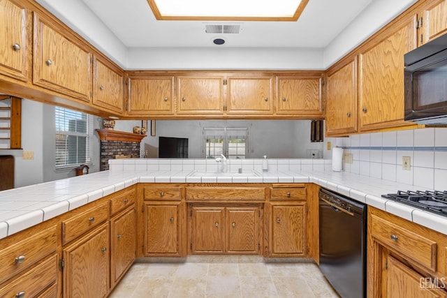 14013 Laverton Ave, Bakersfield, CA 93314 - kitchen with black appliances, a sink, brown cabinets, and light countertops